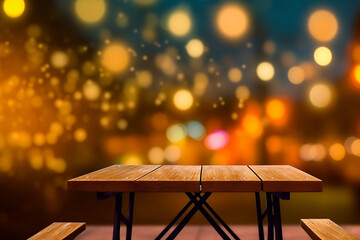 Empty wooden table with benches on bokeh background.