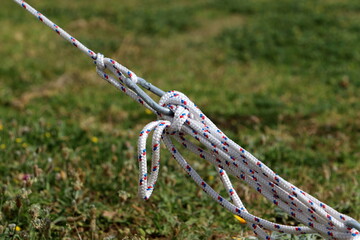 Thick hemp rope on the pier in the seaport.