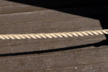 Thick hemp rope on the pier in the seaport.