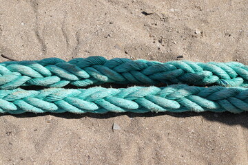 Thick hemp rope on the pier in the seaport.