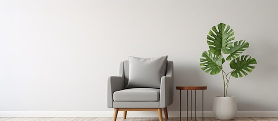 Living room interior with a plant and a poster featuring a grey armchair and wooden table nearby With copyspace for text