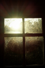 Sunrise through a dirty old window
