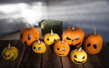scary funny Halloween pumpkins on wooden table
