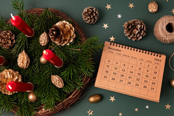 Preparing handmade advent wreath with four candles lit every sunday before christmas and december...