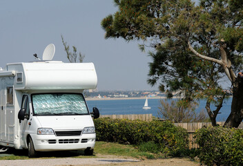 Camper at a camping with view at the sea - obrazy, fototapety, plakaty