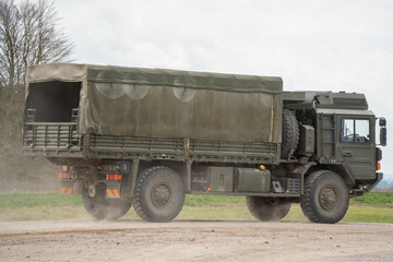 British army MAN SV4x4 Medium Utility Truck driving along a dusty chalk track