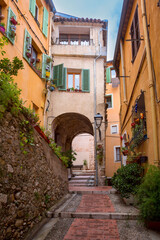 Fototapeta na wymiar Colorful cosy street and houses in the Old Town of Menton, French Riviera, France