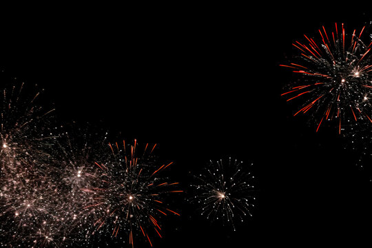 fireworks in black sky against dark background, dark emerald and light amber, decorative backgrounds, with empty copy space