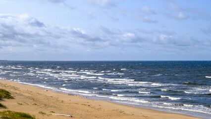 View of the Baltic Sea coastline, Latvia. Beautiful sea coast on a sunny autumn day. Sea waves. Latvian natural landscape. Windy weather. Gulf of Riga