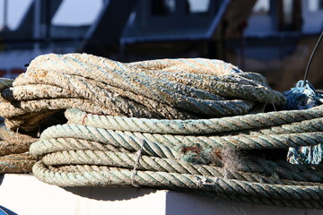 Thick hemp rope on the pier in the seaport.