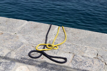 Thick hemp rope on the pier in the seaport.