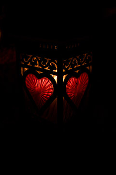 Lit grave candle with red heart motif decorating a grave, surrounded by darkness &mdash; Poland, November 1, All Saints&rsquo; Day (also known as All Souls&rsquo; Day / Day of the Dead)