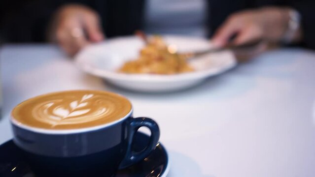 the waiter served cappuccino, shrimp spaghetti and tofu mapo on restaurant table