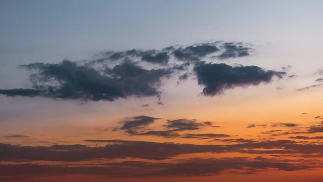 beautiful time lapse footage of a dramatic red and blue sunset sky