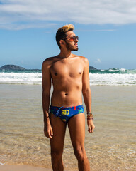 Fototapeta na wymiar brazilian man on gay beach ipanema rio de janeiro on a sunga