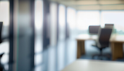 Blurry out of focus background of a bright clean office with desks, computer screens and chairs