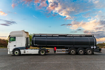 Tanker truck with dangerous goods due to contamination parked in a service area. Side view.