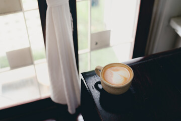 Hot latte coffee in the cafe with copy space for text.