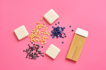 Different types of wax for depilation top view on a pink background