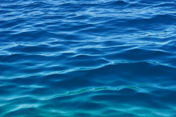 Gradient blue and turquoise colors of wavy blue deep sea water