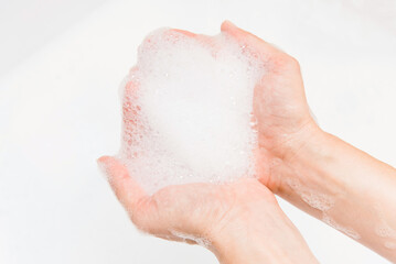 Female hand with soap foam close up view.