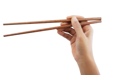 Foto op Canvas Hand holding wooden chopsticks isolated on transparent background. © Phuangphet