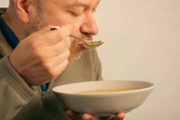 43 year old man eats soup