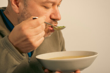 43 year old man eats soup