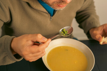 43 year old man eats soup
