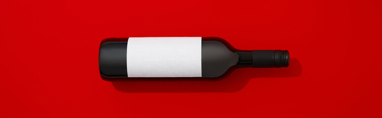 Wine bottle with blank label. Red wine on colorful background with copy space