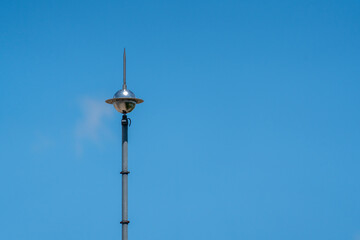 Lightning rod on the roof of a building against a blue sky. Lightning strike