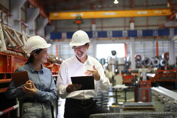 worker or engineer working in factory with safety uniform , safety hat and safety glasses , image is safety concept or happy workplace - obrazy, fototapety, plakaty