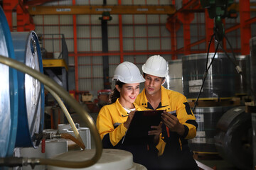 worker or engineer working in factory with safety uniform , safety hat and safety glasses , image is safety concept or happy workplace