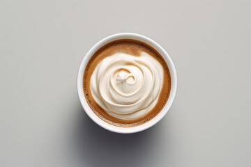 top down view of cream in a single coffee cup - obrazy, fototapety, plakaty
