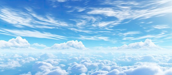 Pale blue sky with clouds and a plane contrail displaying a gradient of color and illumination above the horizon With copyspace for text