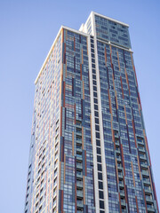 Obraz premium High-rise building of unusual architecture. Facade of a modern building. Hotel and apartments.