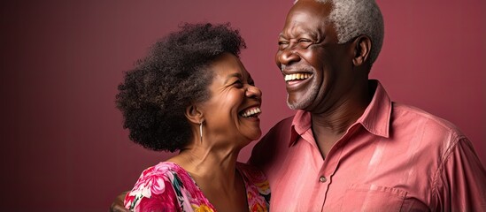 Elderly African American man and woman joyfully dancing together in nursing home sharing laughter friendship and happiness With copyspace for text