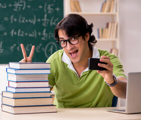 Handsome student in front of chalkboard with formulas