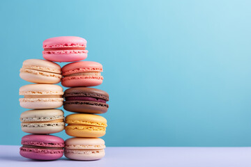 Many different macaroons on solid color background with copy space. horizontal composition
