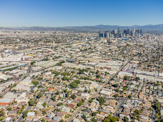 Los Angeles, California – October 6, 2023: aerial drone wide view toward 27th St historic district, south-central, with LA downtown, homes, houses, apartments, buildings