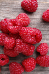 Tasty ripe raspberries on wooden table, top view