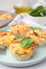 Freshly baked bacon and egg muffins with cheese on table, closeup