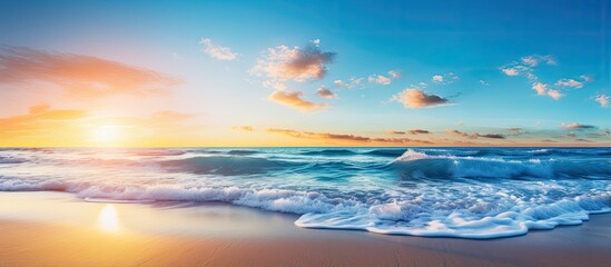 Vibrant dawn at the beach with blue sky and sunbeams With copyspace for text