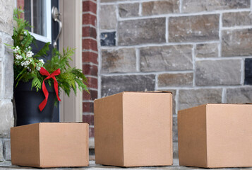 Parcel boxes on front porch of a house during Christmas time