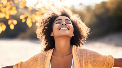 Backlit Portrait of calm happy smiling free black woman with closed eyes enjoys a beautiful moment life on the fields at sunset - obrazy, fototapety, plakaty
