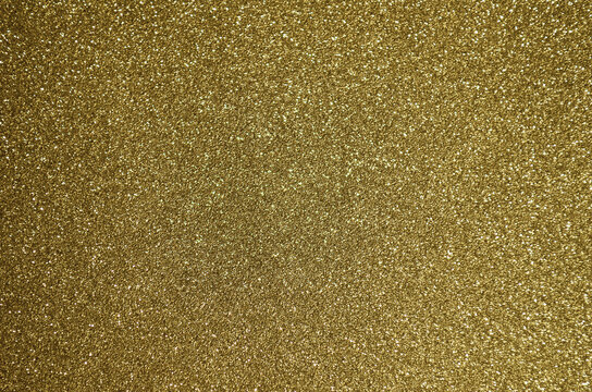 Fototapeta Fondo de brillos / textura glitter de color amarillo dorado. Se puede usar como fondo de año nuevo o navidad.