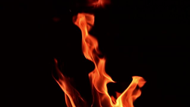 Fire flames rising in the air. Bonfire burning in the dark. Close up.