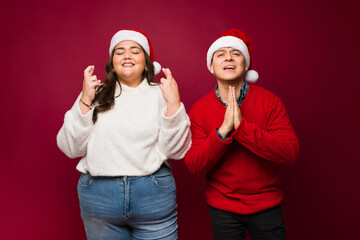 Sad couple asking for a christmas miracle and praying