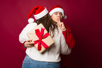 Boyfriend keeping a secret from his girlfriend on christmas