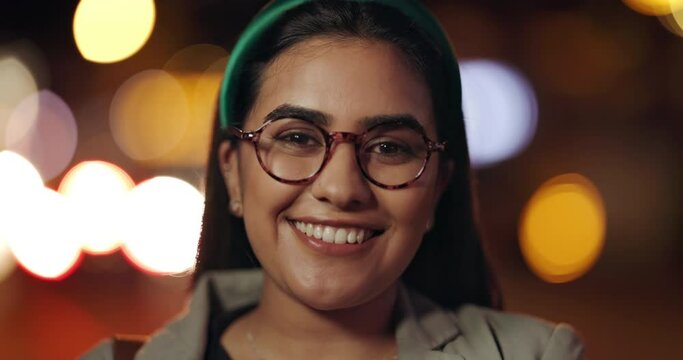 Smile, face and woman in a city at night for travel, freedom or fun outdoor on bokeh background. Happy, portrait and female traveler explore downtown with positive attitude, mindset or feel good mood